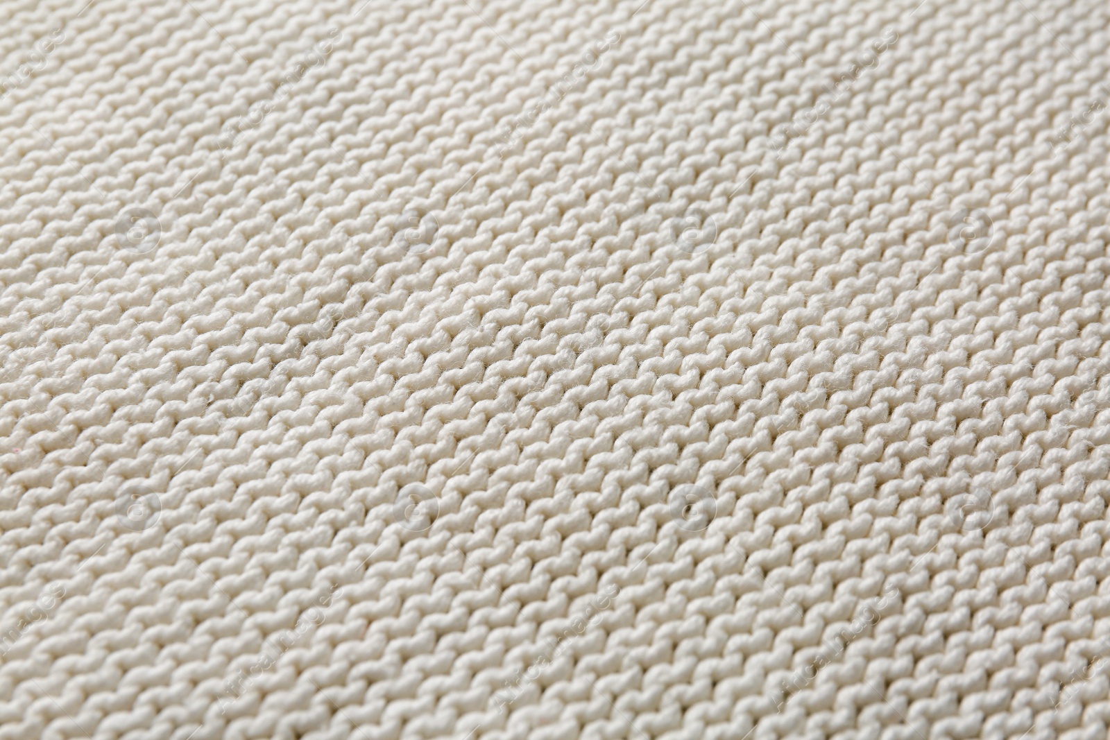 Photo of Beautiful white knitted fabric as background, closeup