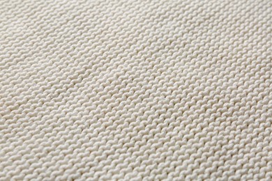 Photo of Beautiful white knitted fabric as background, closeup