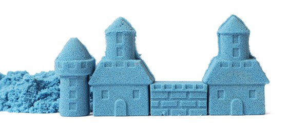 Photo of Castle made of blue kinetic sand isolated on white