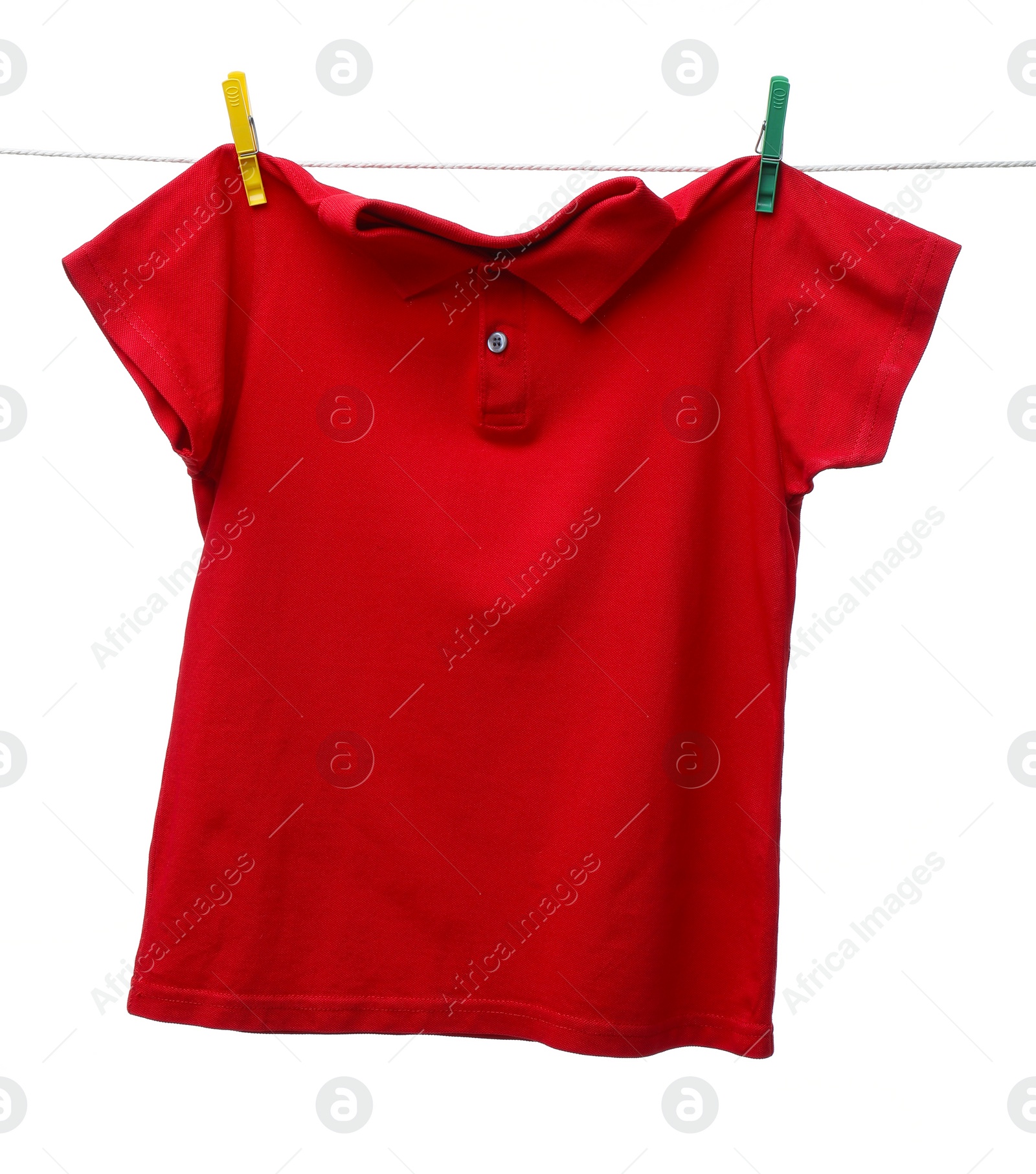 Photo of One red t-shirt drying on washing line isolated on white