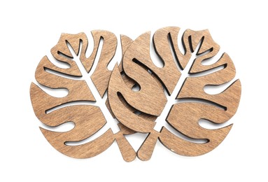 Photo of Leaf shaped wooden cup coasters on white background, top view