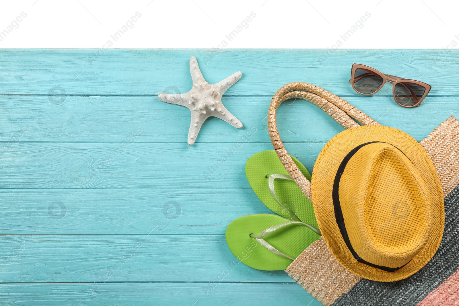 Photo of Flat lay composition with beach accessories on wooden background. Space for text