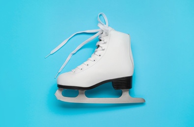 Figure ice skate on light blue background, top view