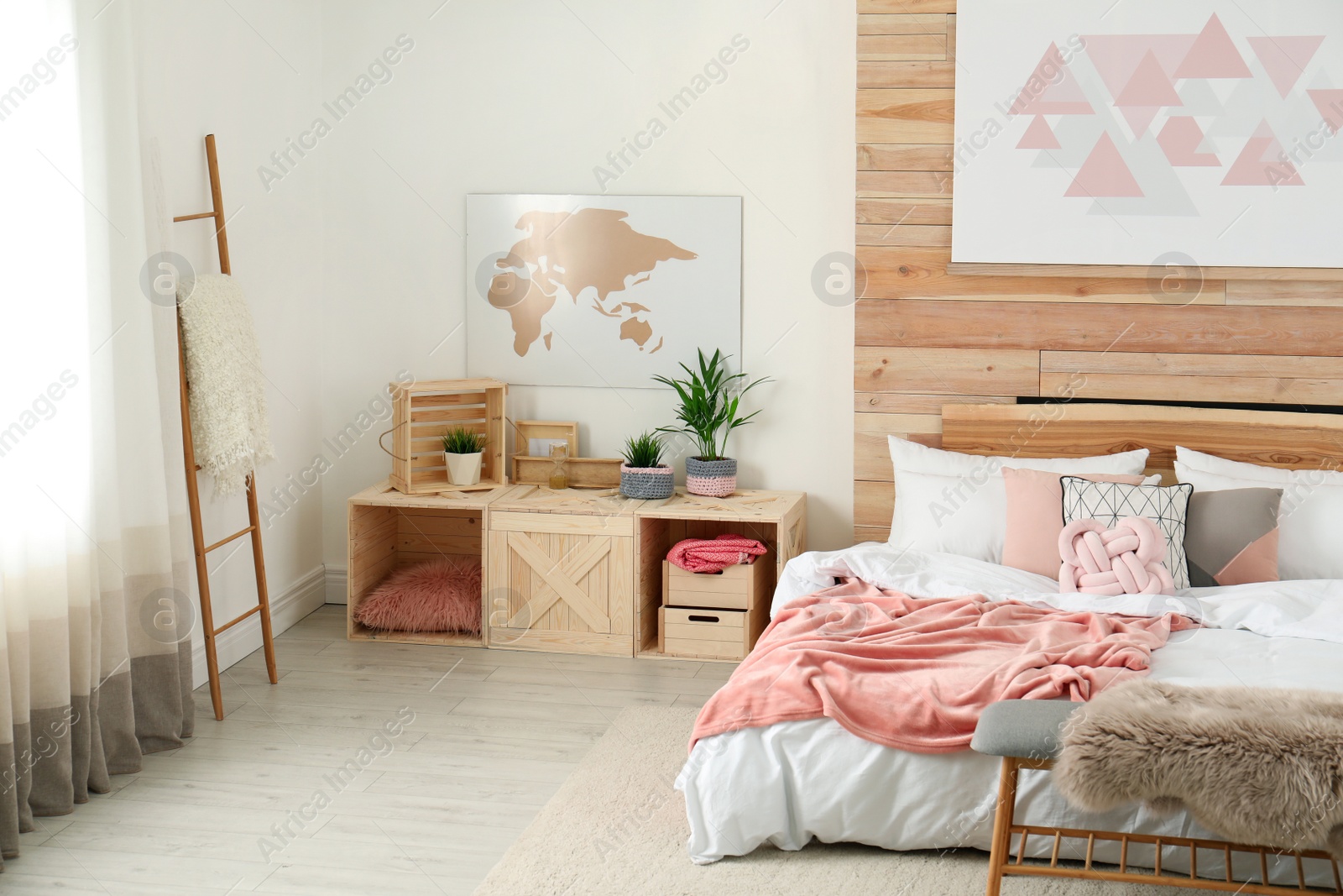 Photo of Stylish room interior with comfortable bed near wooden wall