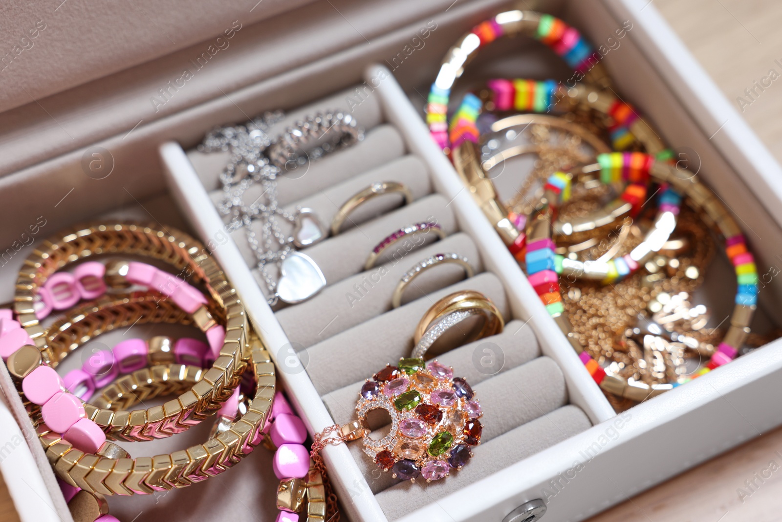 Photo of Jewelry box with beautiful bracelets and other accessories, closeup