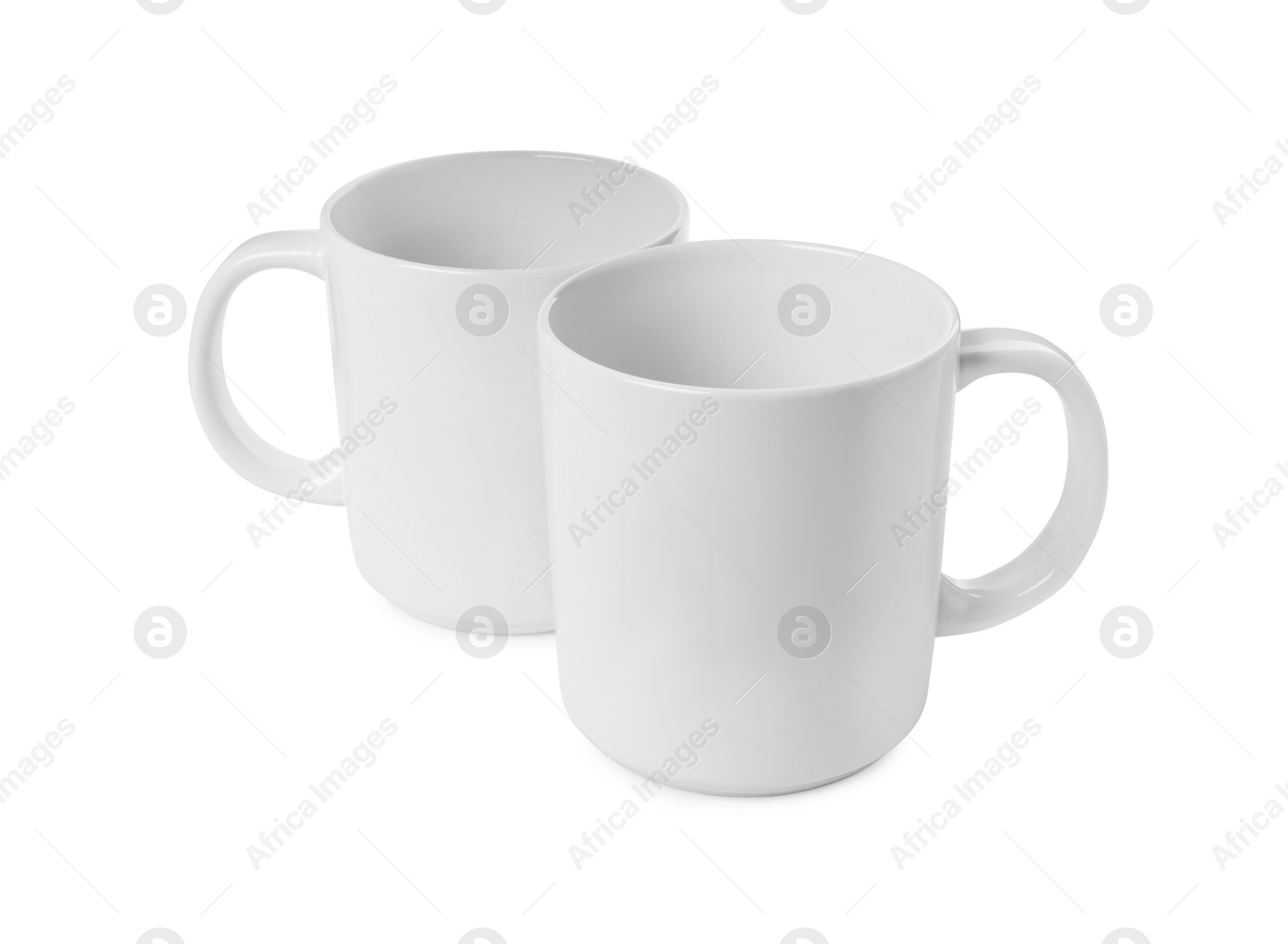 Photo of Two light ceramic mugs isolated on white