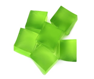 Heap of green jelly cubes on white background, top view