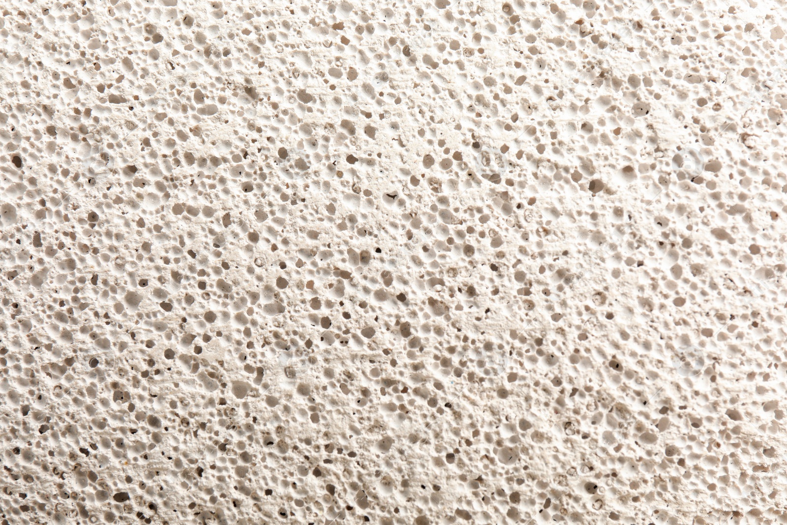 Photo of Texture of white pumice stone as background, closeup