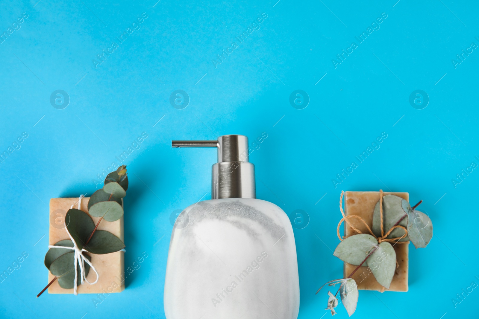 Photo of Flat lay composition with marble soap dispenser on light blue background. Space for text