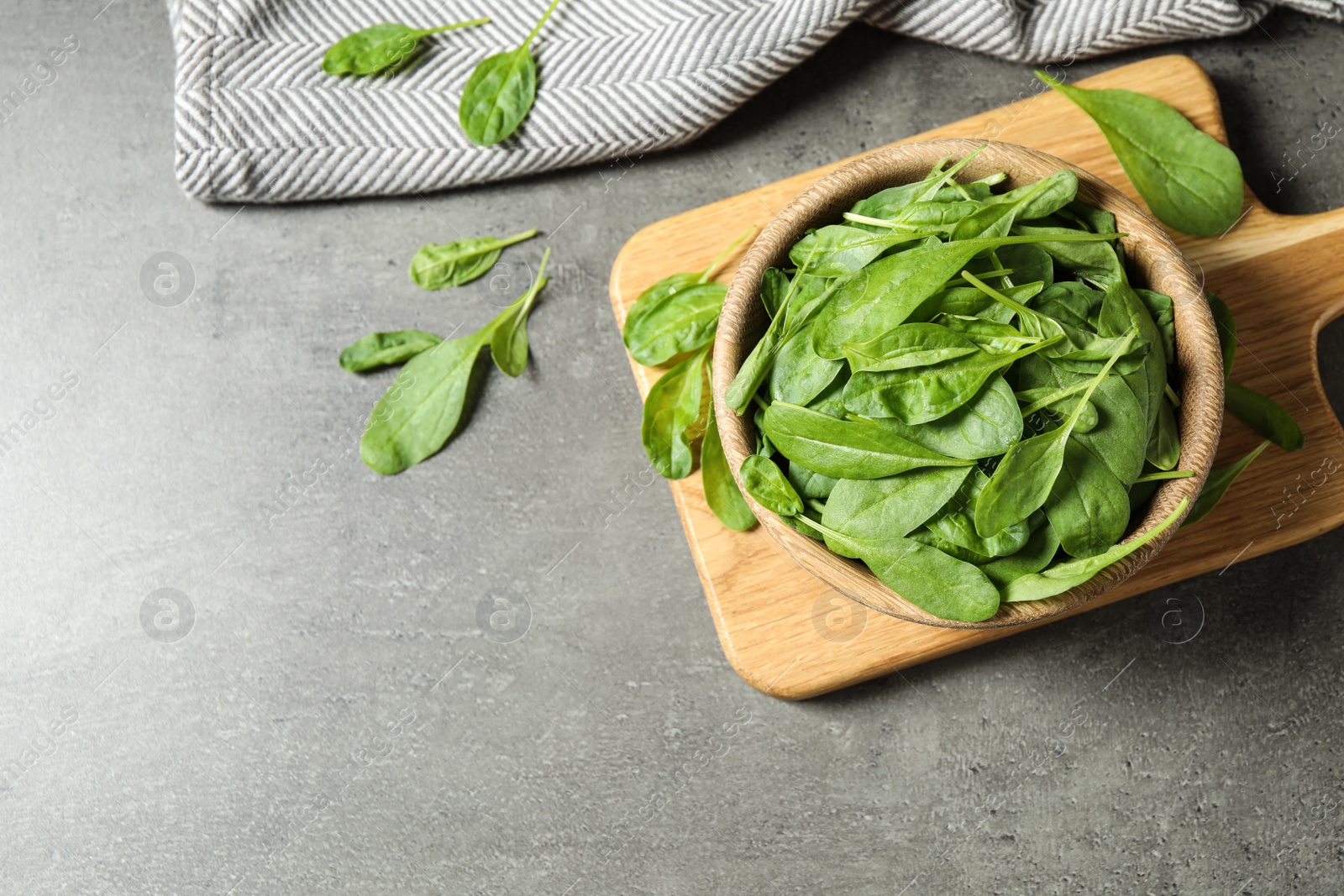 Photo of Fresh green healthy spinach on grey table, flat lay. Space for text