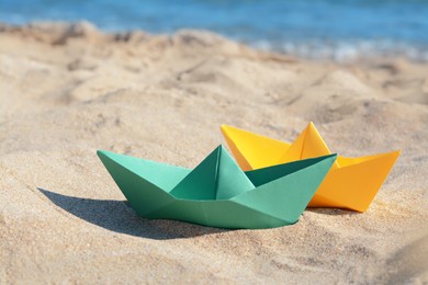 Two paper boats near sea on sunny day