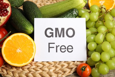Photo of Tasty fresh GMO free products and paper card, closeup