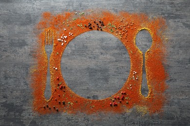 Photo of Silhouettes of cutlery and plate made by spices on grey table, flat lay. Space for text
