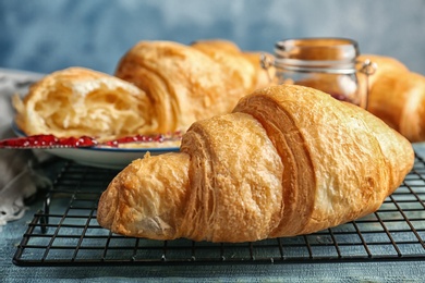 Photo of Tasty croissant on table, closeup