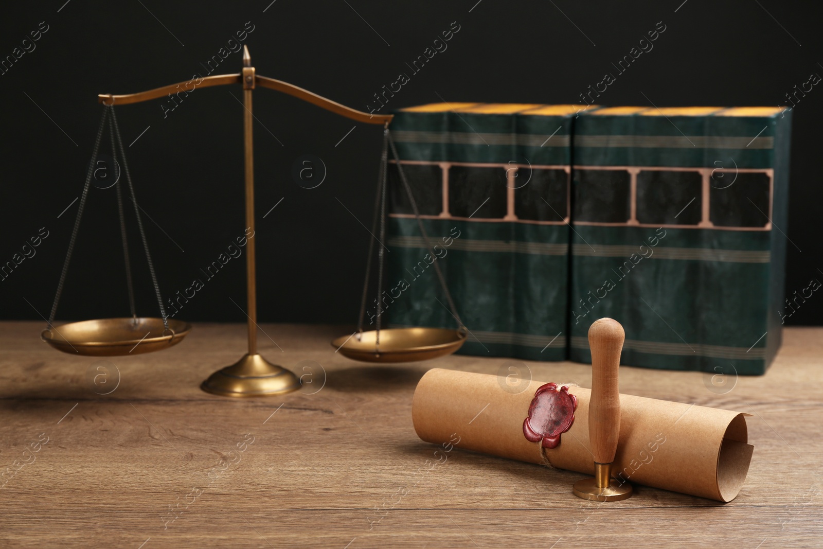 Photo of Notary's public pen, sealed document and scales on wooden table