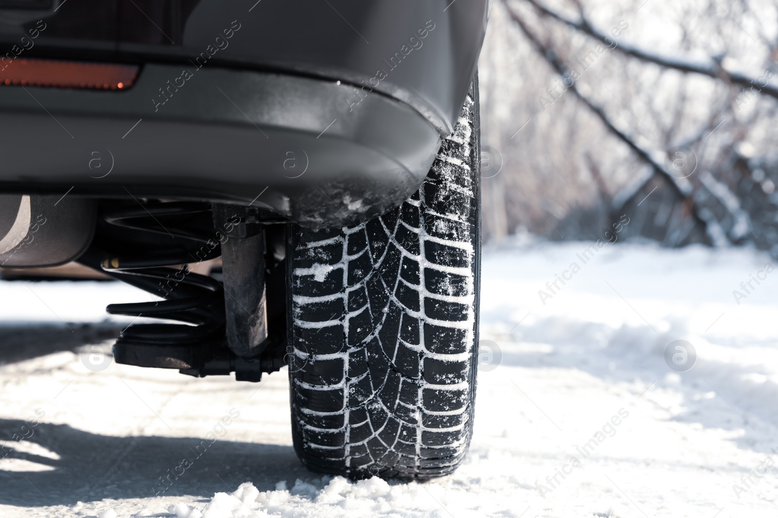 Photo of Car with winter tires on snowy road, closeup view