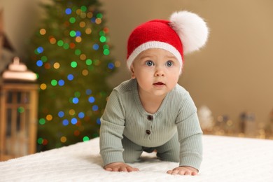 Cute little baby in room decorated for Christmas. Winter holiday