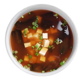 Photo of Bowl of delicious miso soup with tofu isolated on white, top view