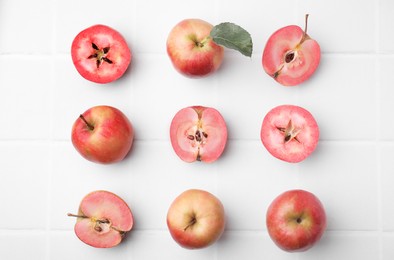 Tasty apples with red pulp on white background, flat lay