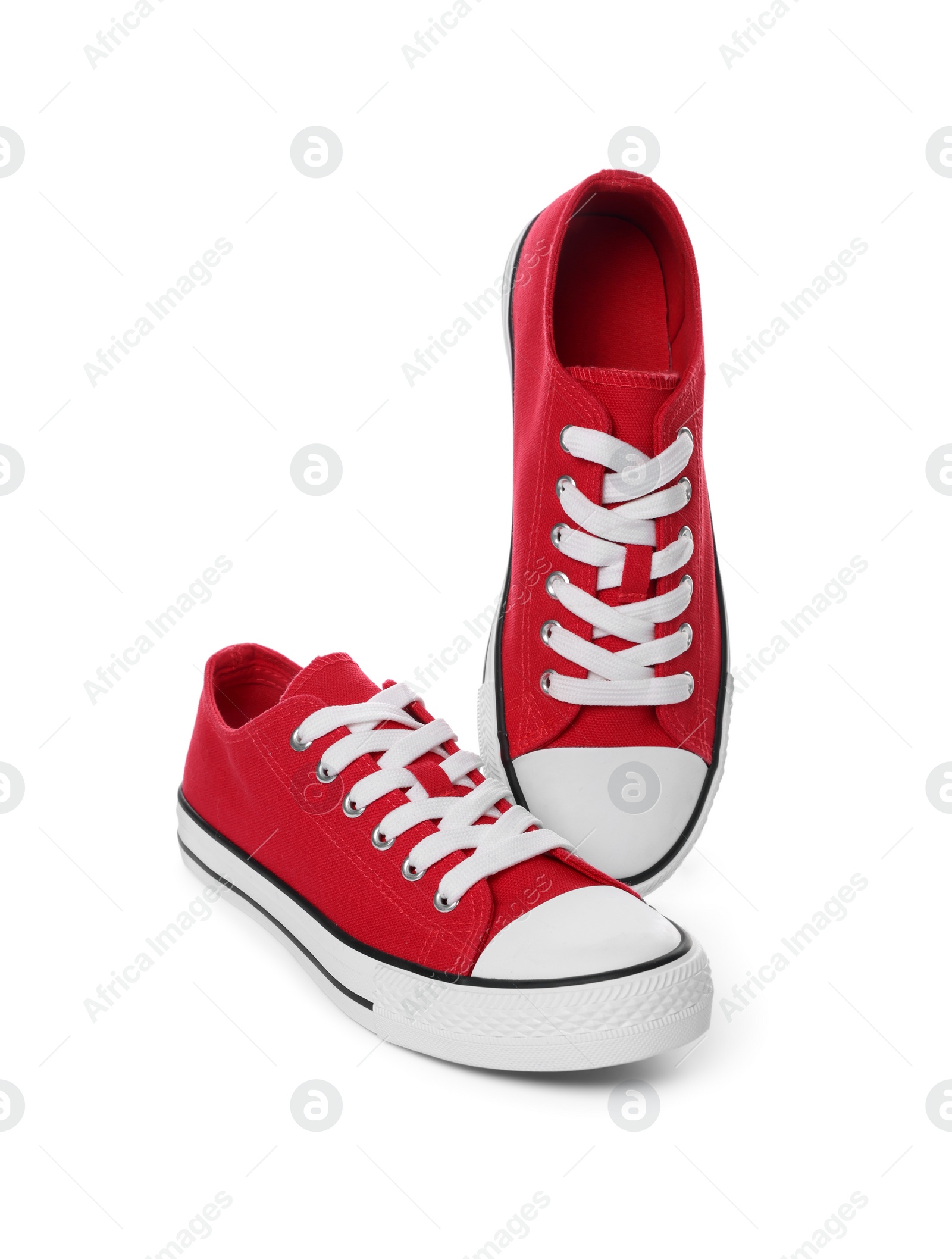 Photo of Pair of red classic old school sneakers on white background