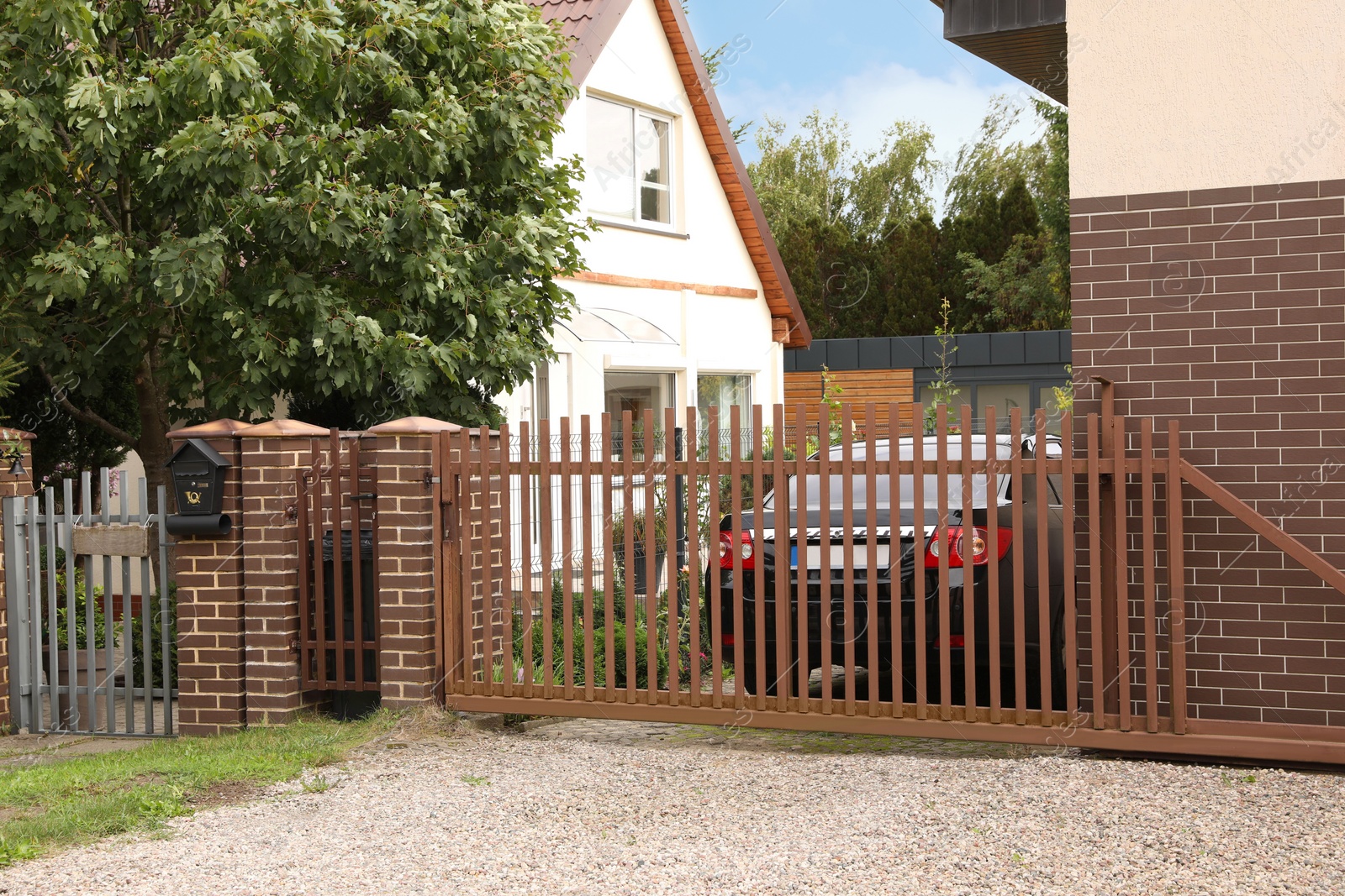 Photo of Brown metal gates near private houses on street