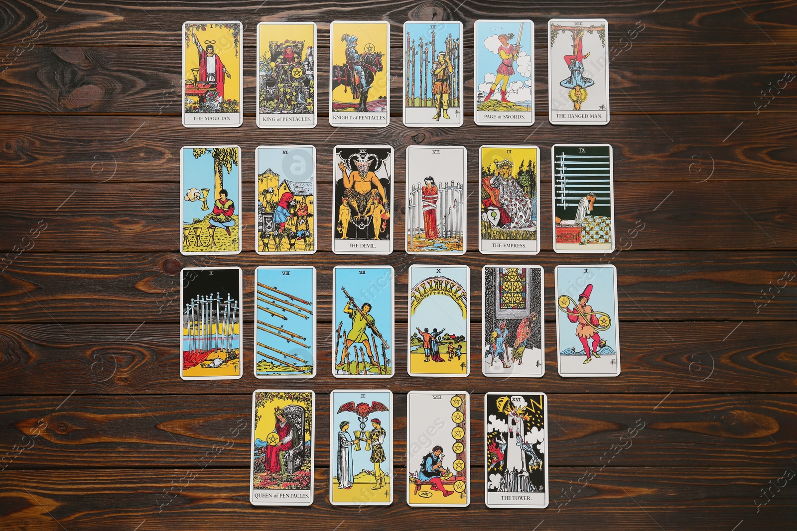 Photo of Tarot cards on wooden table, flat lay