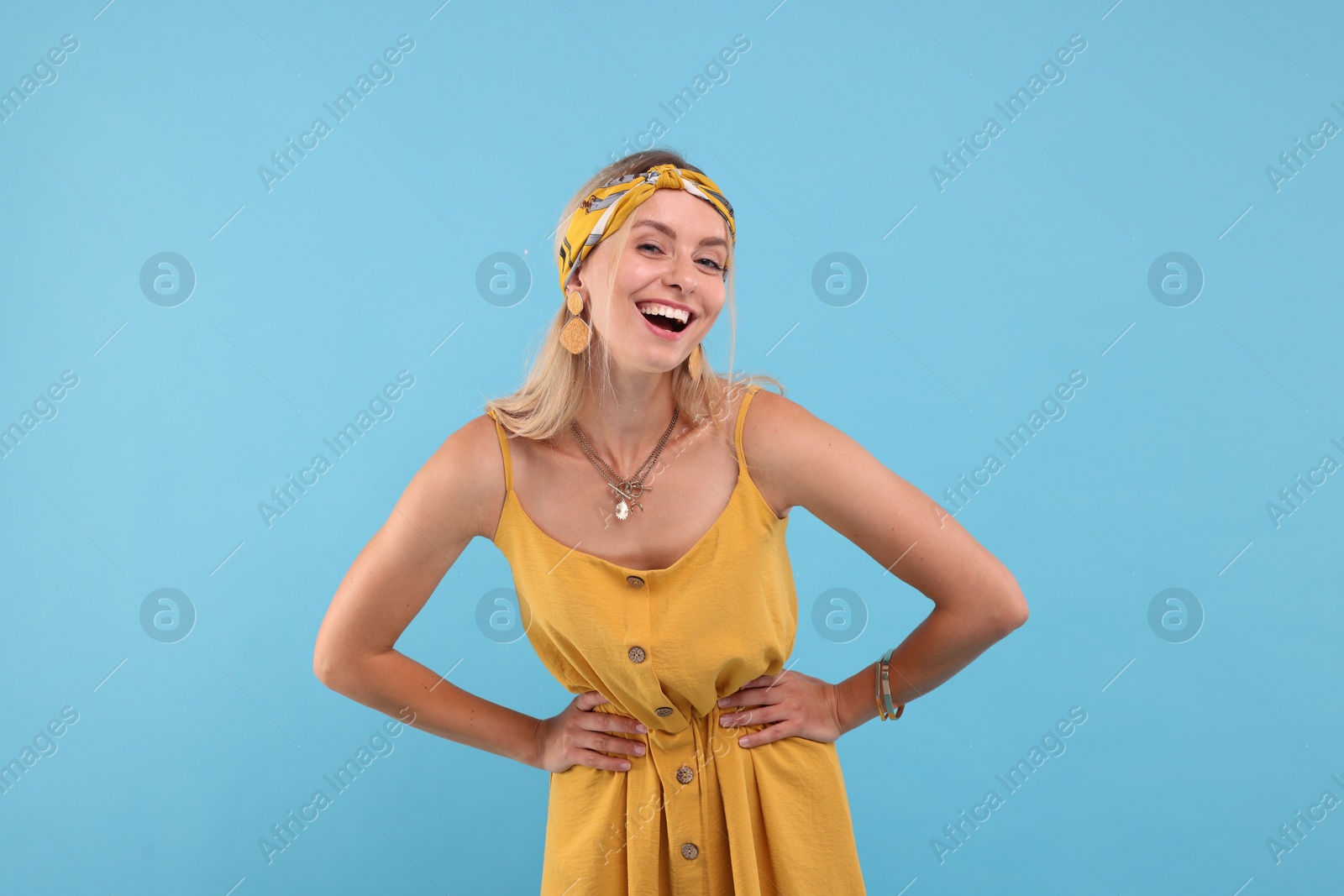 Photo of Portrait of happy hippie woman on light blue background