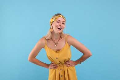 Photo of Portrait of happy hippie woman on light blue background