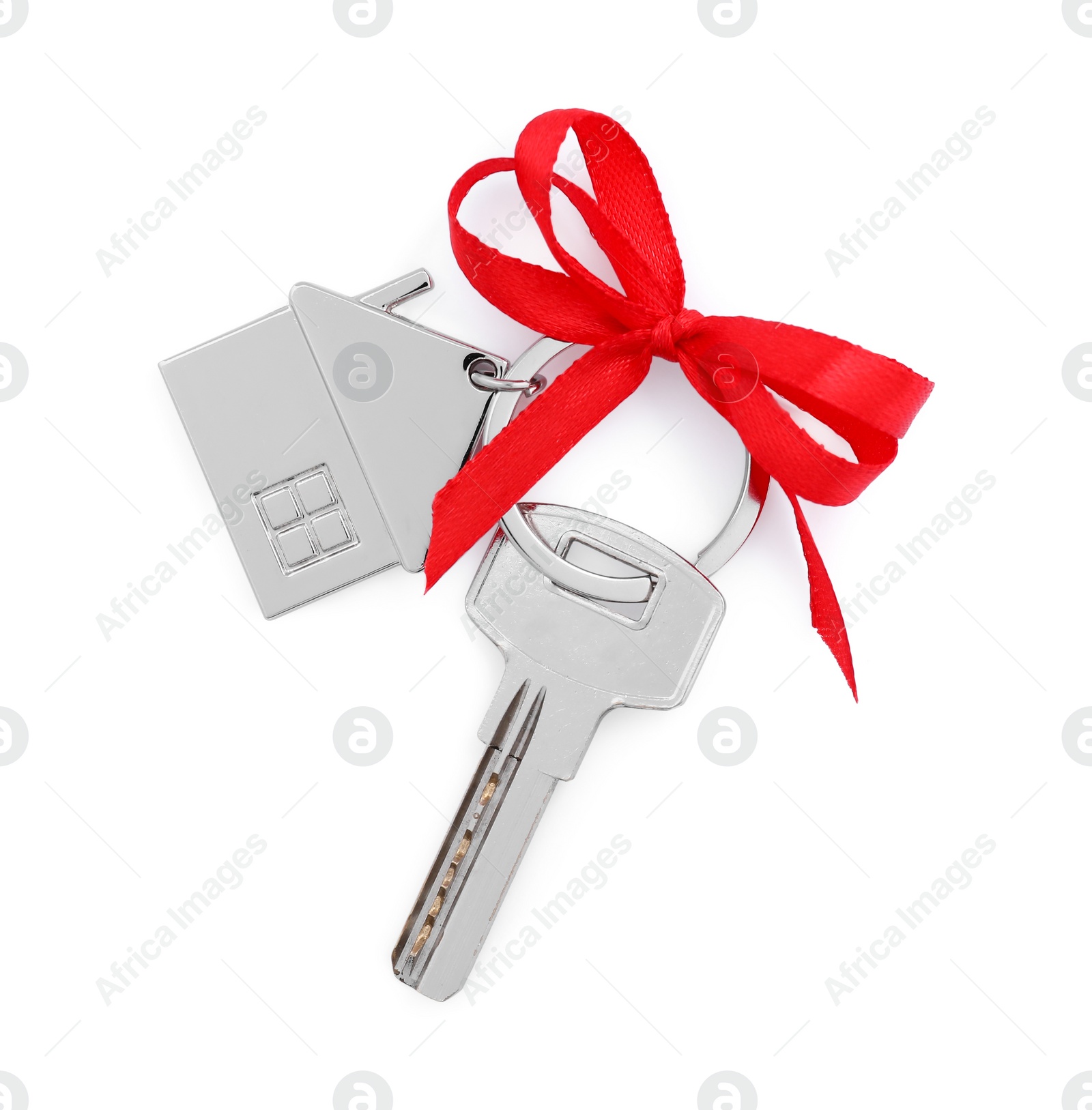 Photo of Key with keychain in shape of house and red bow isolated on white, top view