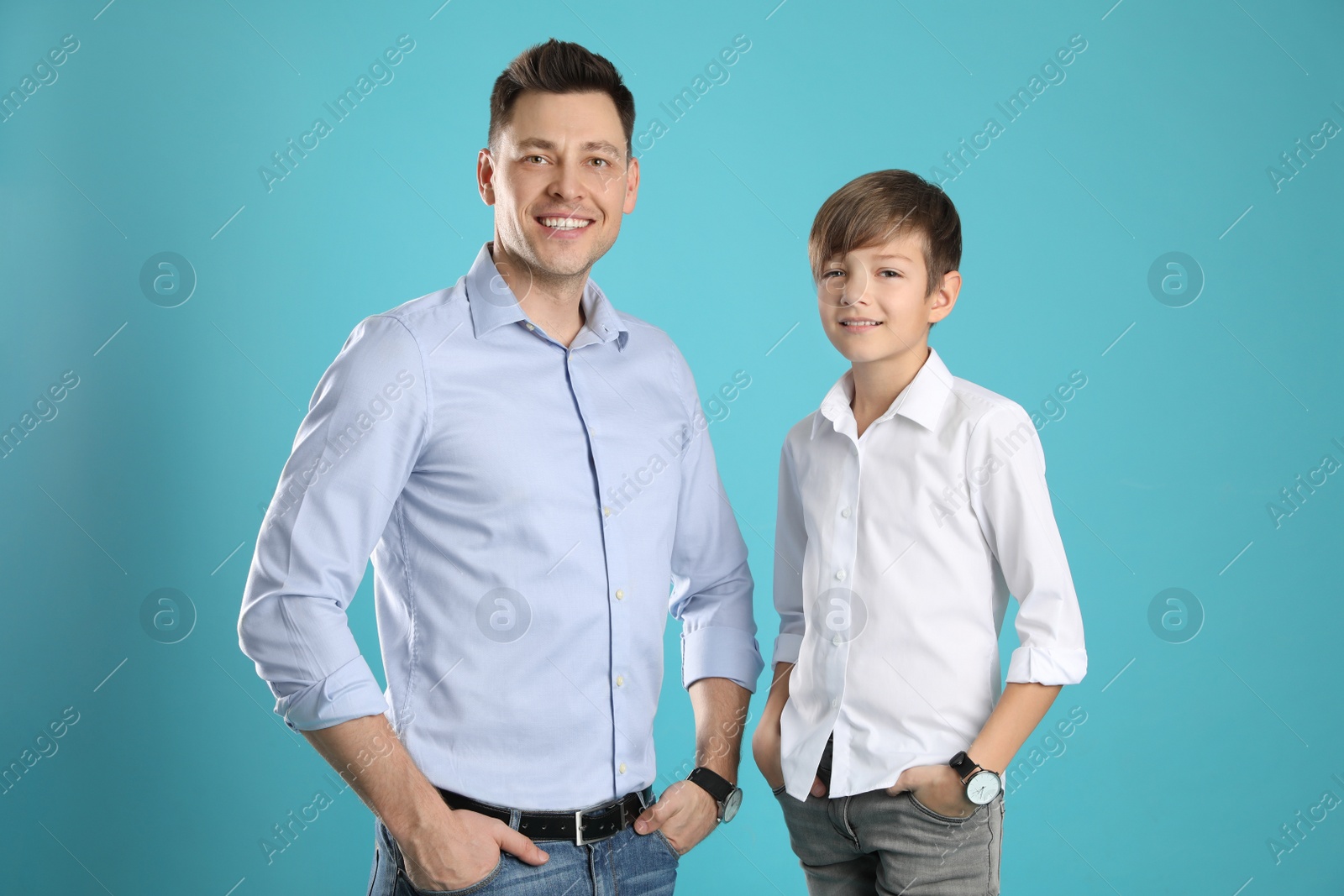 Photo of Portrait of dad and his son on color background