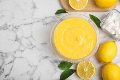 Delicious lemon curd and fresh fruits on white marble table, flat lay. Space for text