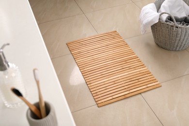 Wooden mat on floor in bathroom. Interior design