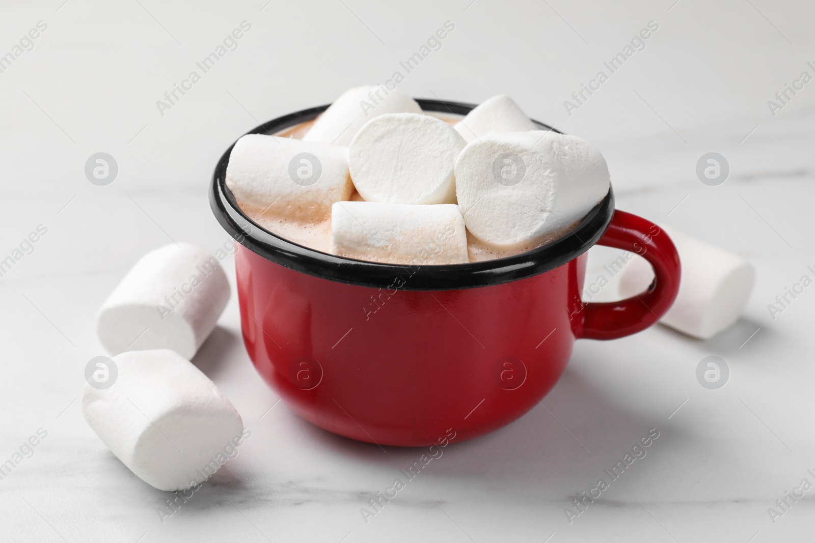 Photo of Tasty hot chocolate with marshmallows on white marble table, closeup