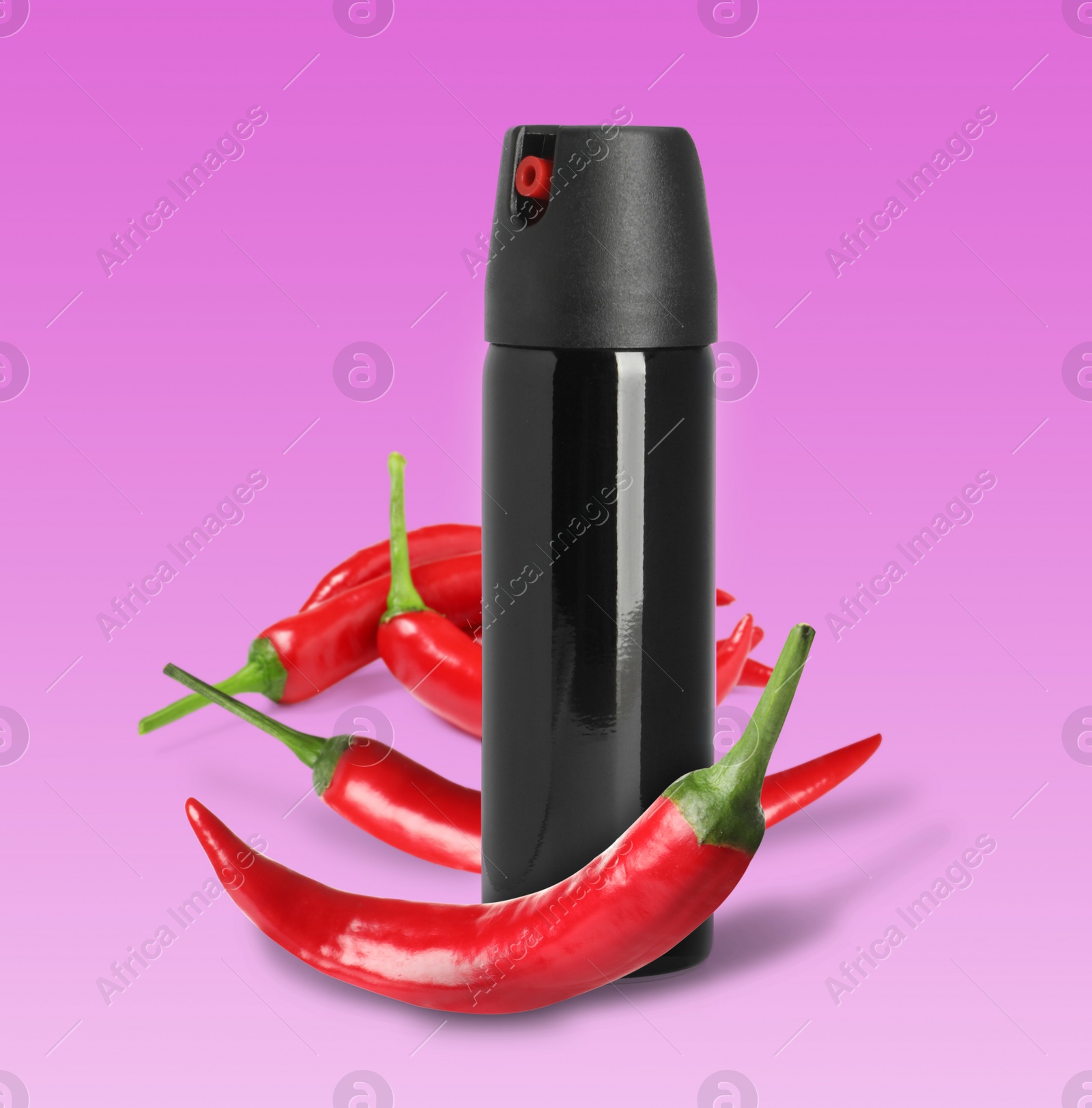 Image of Bottle of pepper spray and red hot chilies on pink background