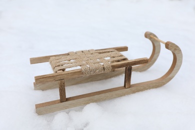 Photo of Wooden sleigh on snow outdoors. Winter activity