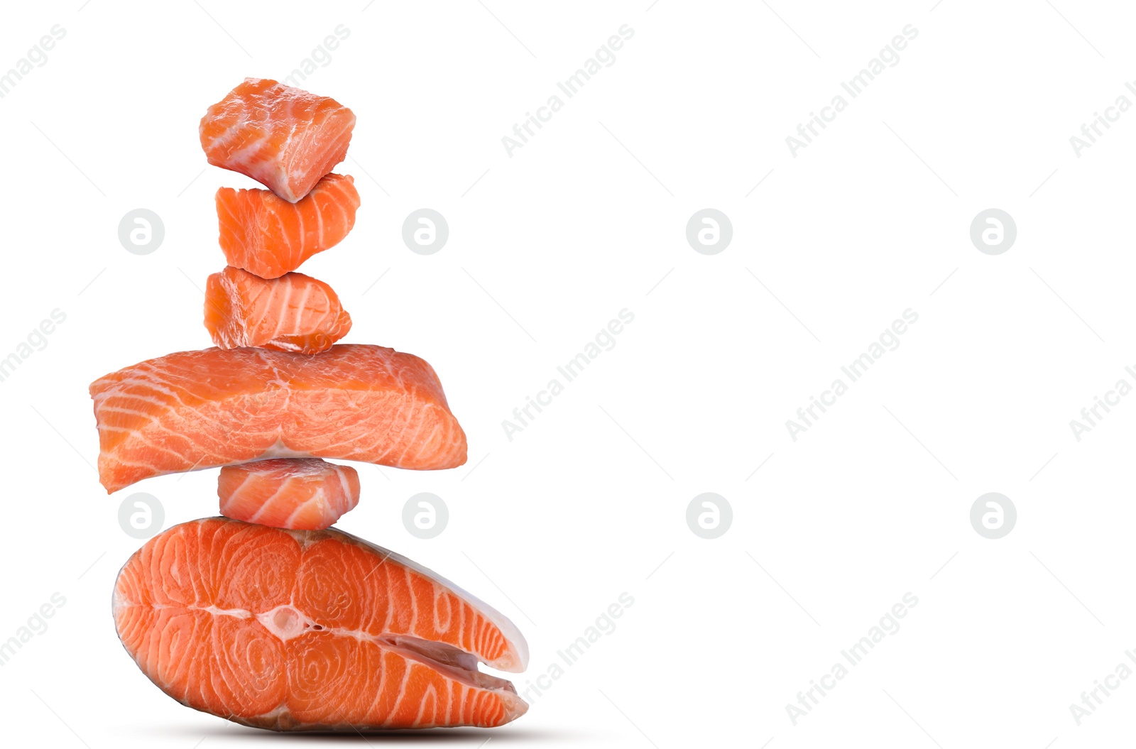 Image of Cut fresh salmon falling on white background