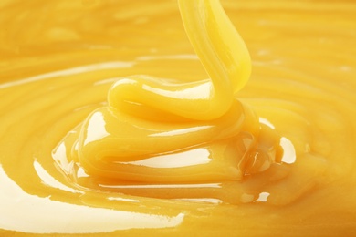 Photo of Pouring fresh sweet honey, closeup