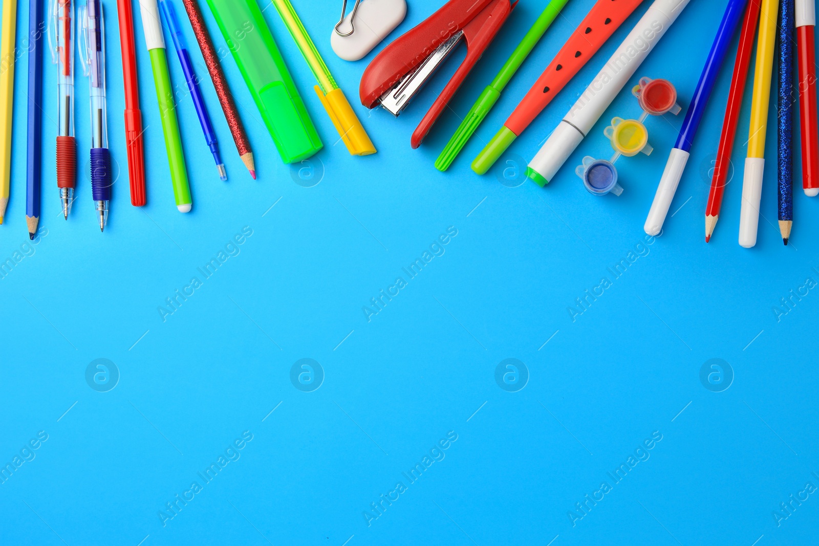 Photo of Flat lay composition with different school stationery on light blue background, space for text. Back to school