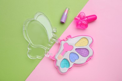 Photo of Decorative cosmetics for kids. Eye shadow palette, lipstick and nail polish on color background, flat lay