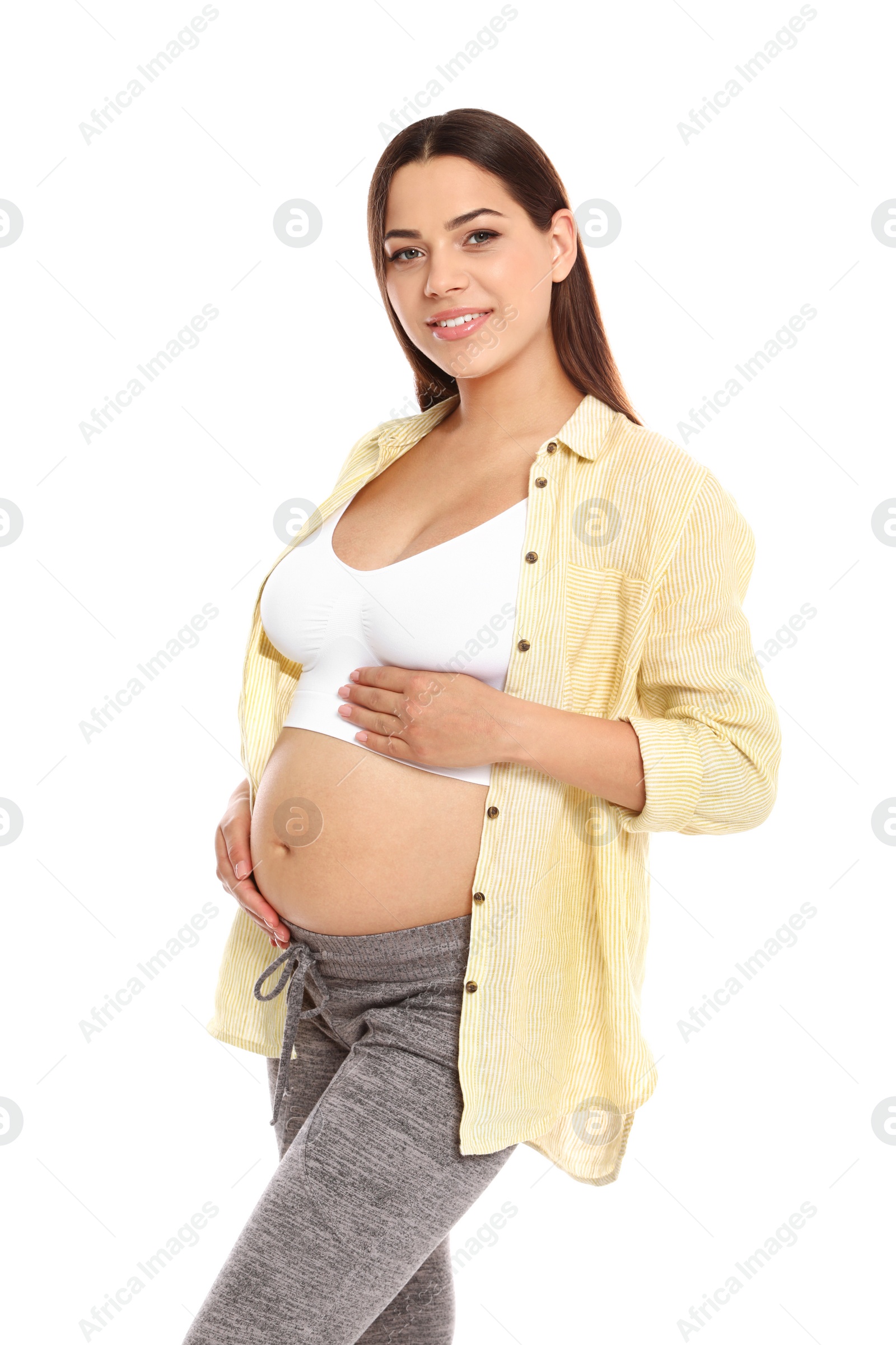 Photo of Portrait of beautiful young pregnant woman in shirt on white background