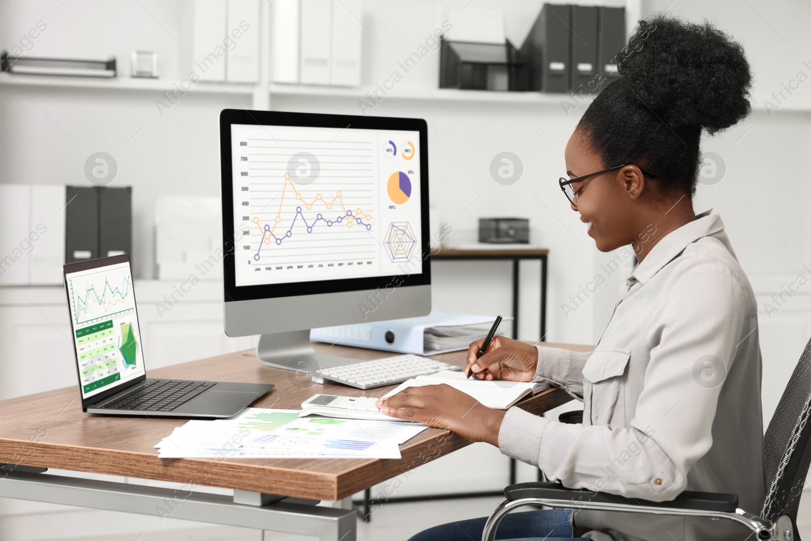 Photo of Professional accountant working at wooden desk in office