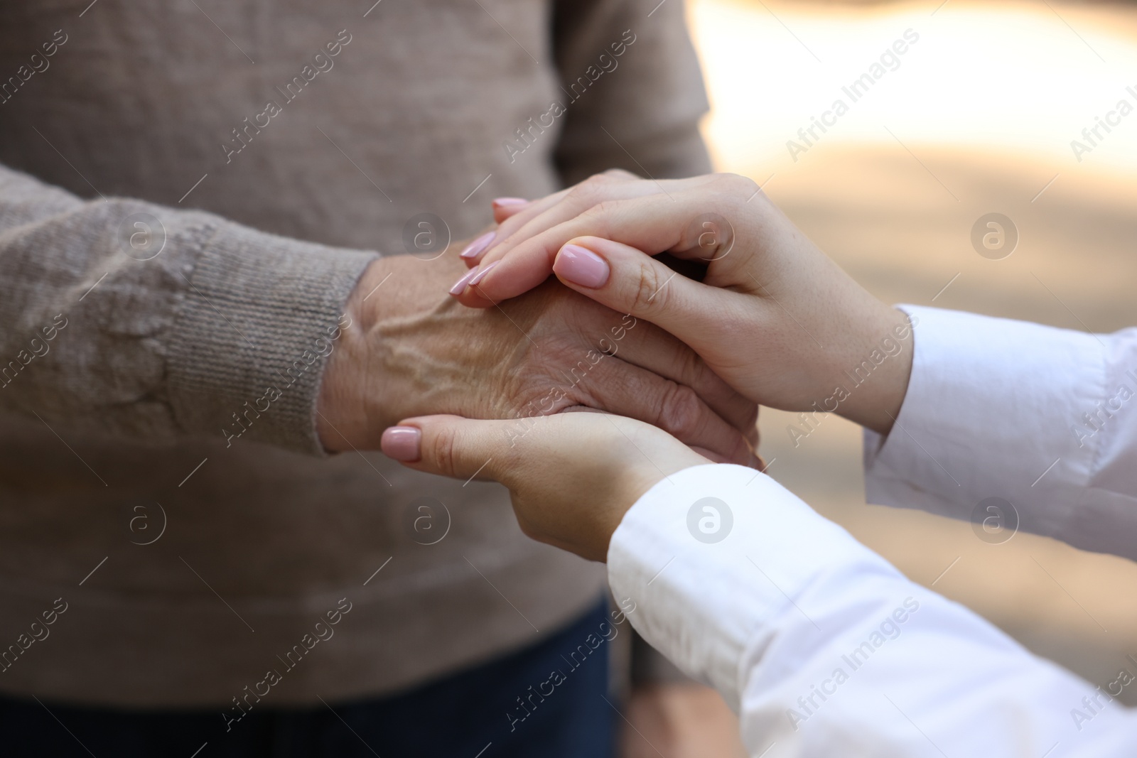 Photo of Trust and support concept. People joining hands outdoors, closeup