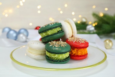 Different decorated Christmas macarons on white table