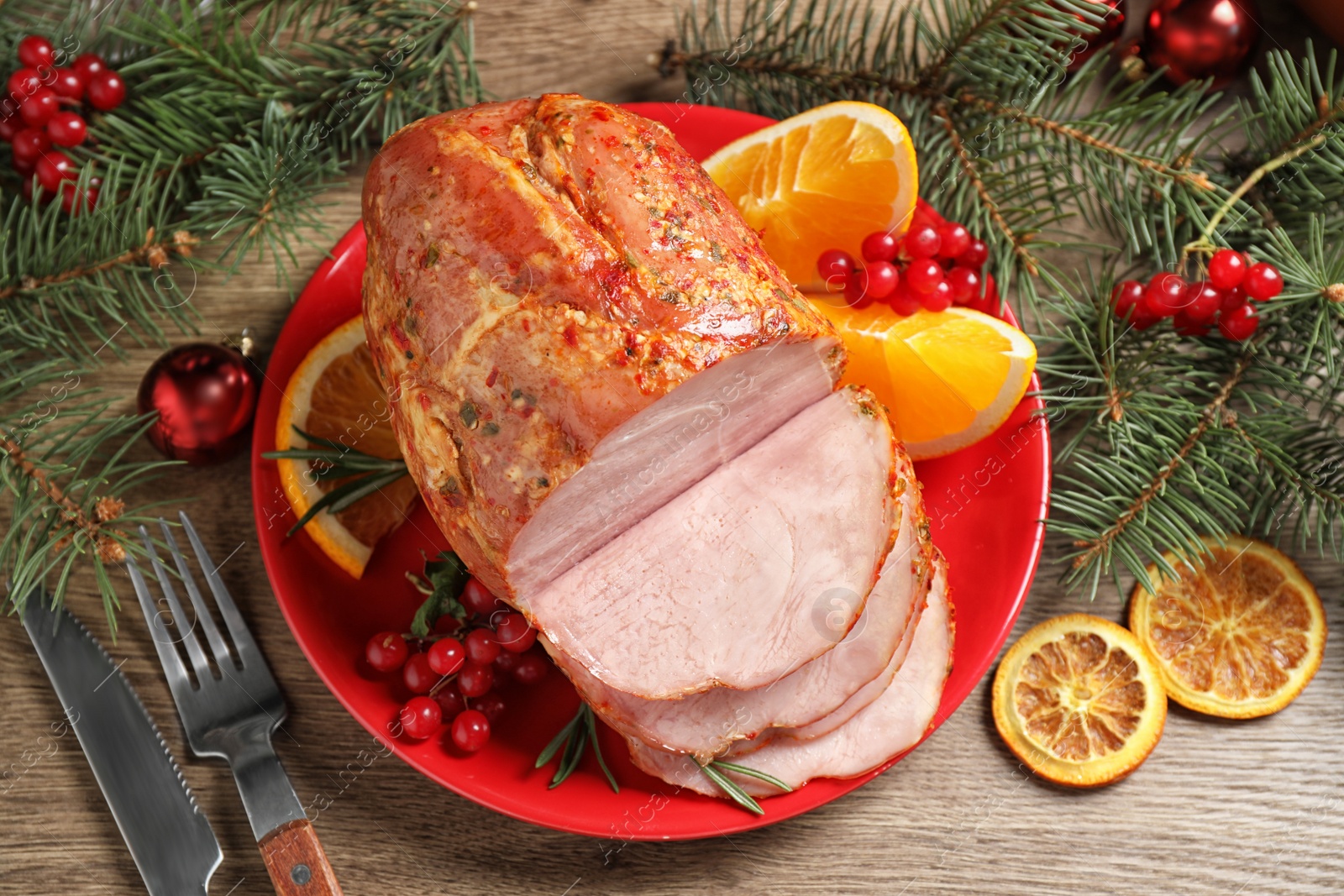 Photo of Plate with delicious ham served on wooden table, flat lay. Christmas dinner