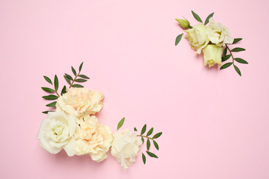 Photo of Flat lay composition with beautiful flowers and space for text on pink background. Floral card design