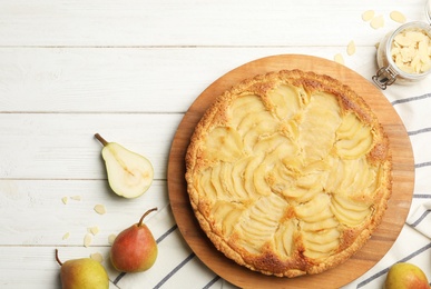 Photo of Delicious sweet pear tart on white wooden table, flat lay. Space for text