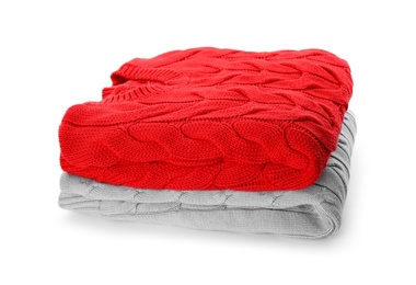 Photo of Stack of different warm sweaters isolated on white