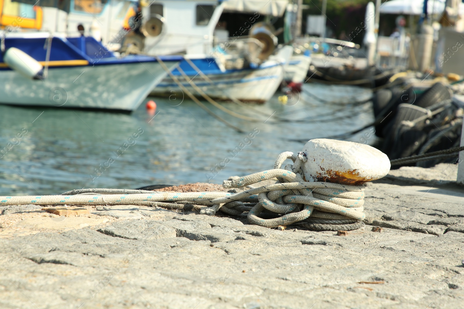 Photo of Mooring pole with rope in sea port