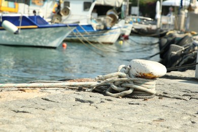 Mooring pole with rope in sea port