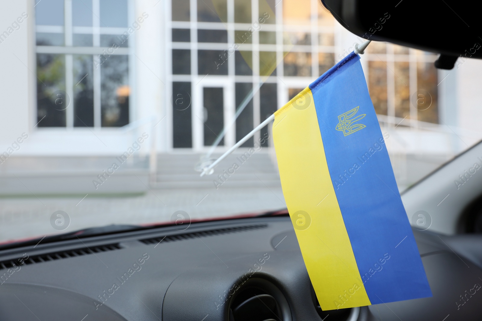 Photo of National flag of Ukraine on windshield inside car